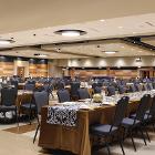 Image of long table at extreme angle with round tables in background.