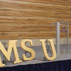 Image of MSU letters and podium on stage.