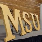 Image of MSU letters with podium on stage.