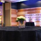 Image of flowers on round standing table with black tablecloth.