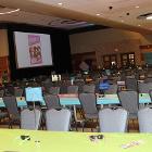 Image of decorated long table with rows of long tables in the background and a screen in the background.