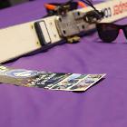 Images of ski and sunglasses on long table with purple tablecloth.