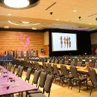 Images of long tables with screen and stage in the background.