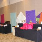 Image of catering tables with colorful designs on walls.