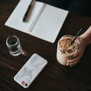 hand holding an iced coffee beverage