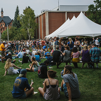 outdoor event with big white tents and hundreds of students