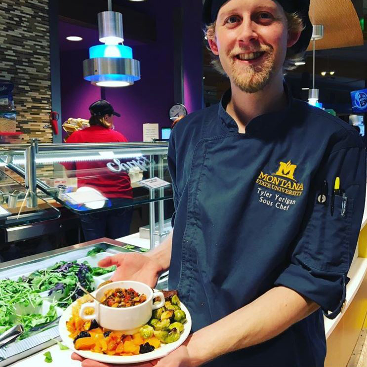 chef holding a plate of food in miller dining hall
