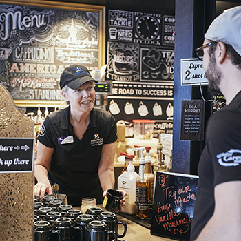 student ordering from a staff member at a coffee shop