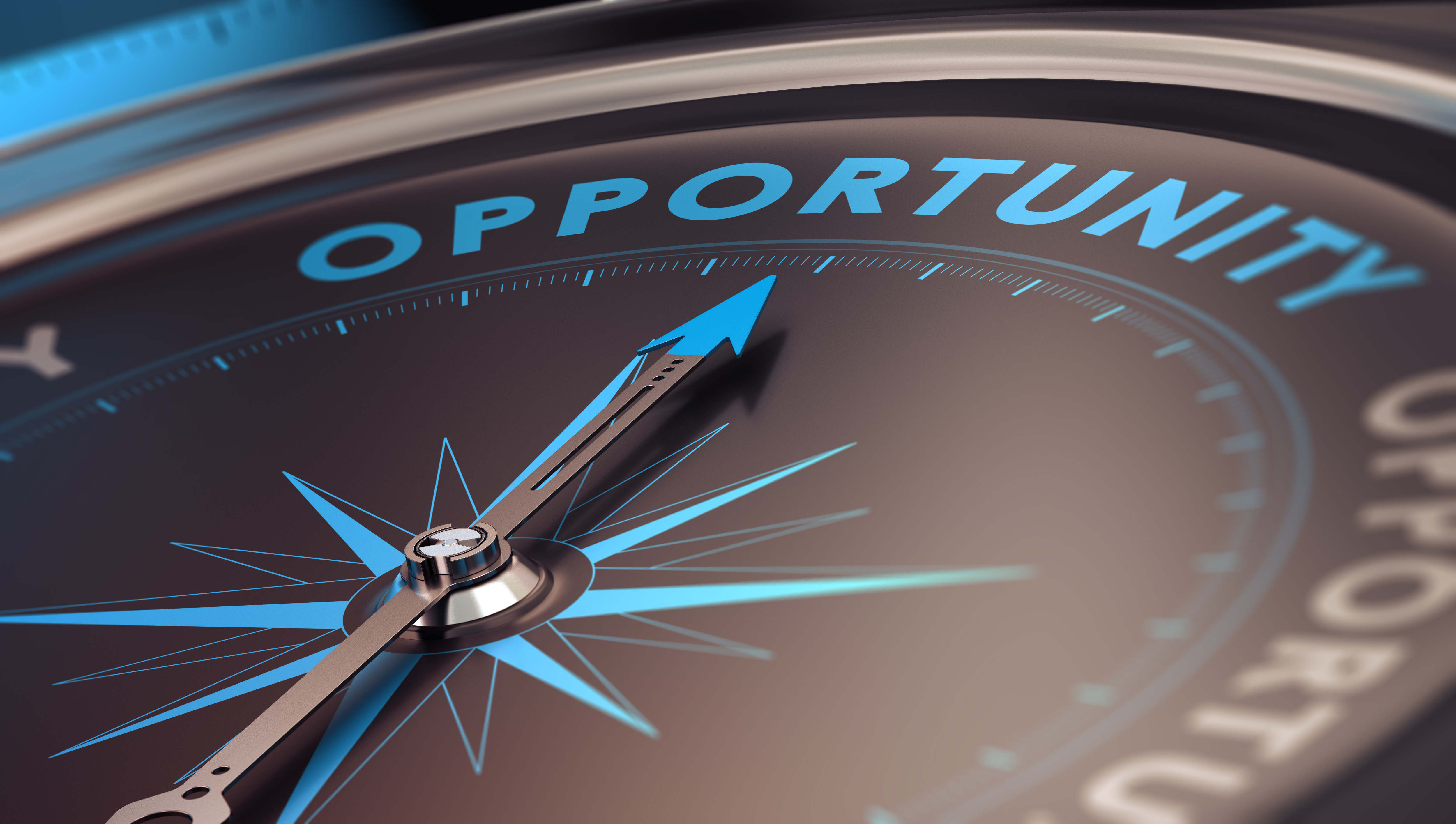 Photo of a compass pointing to the word opportunity
