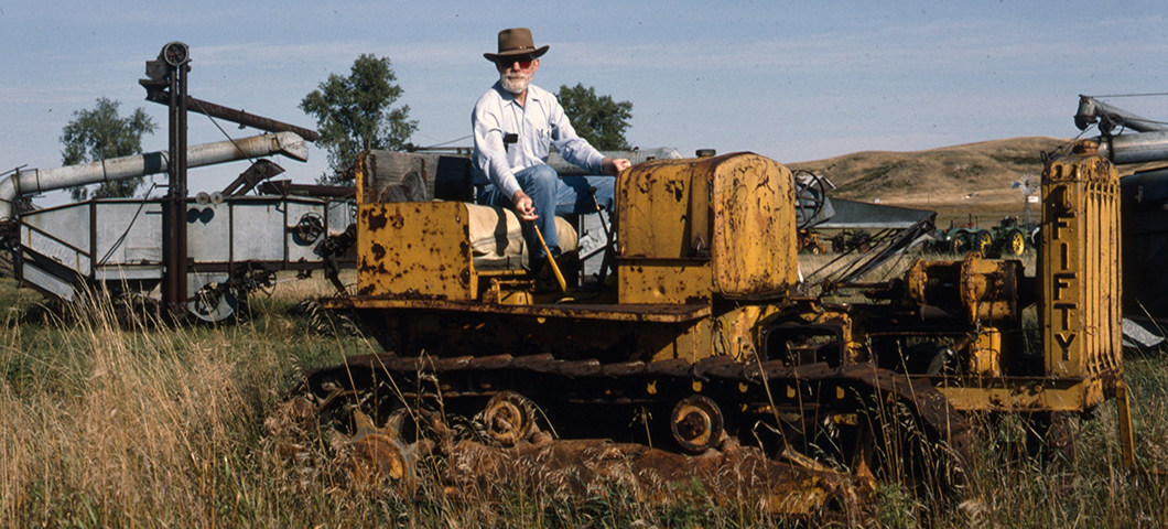 Ivan Doig sitting on Cat at Tractor Museum