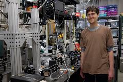 student amongst lab equipment