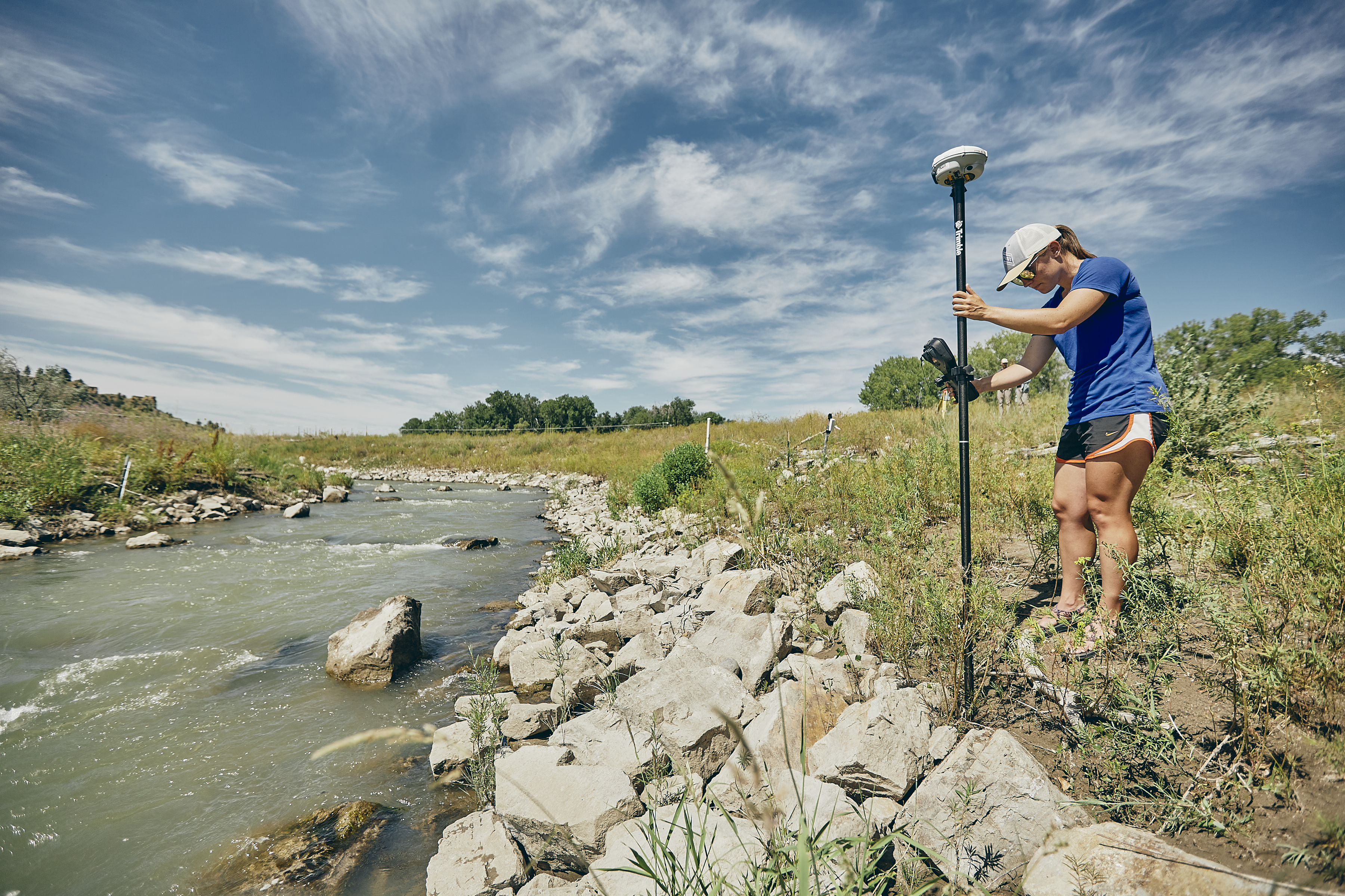 Haley uses GPS surveying equipment to collect topographic data for her hydraulic model.