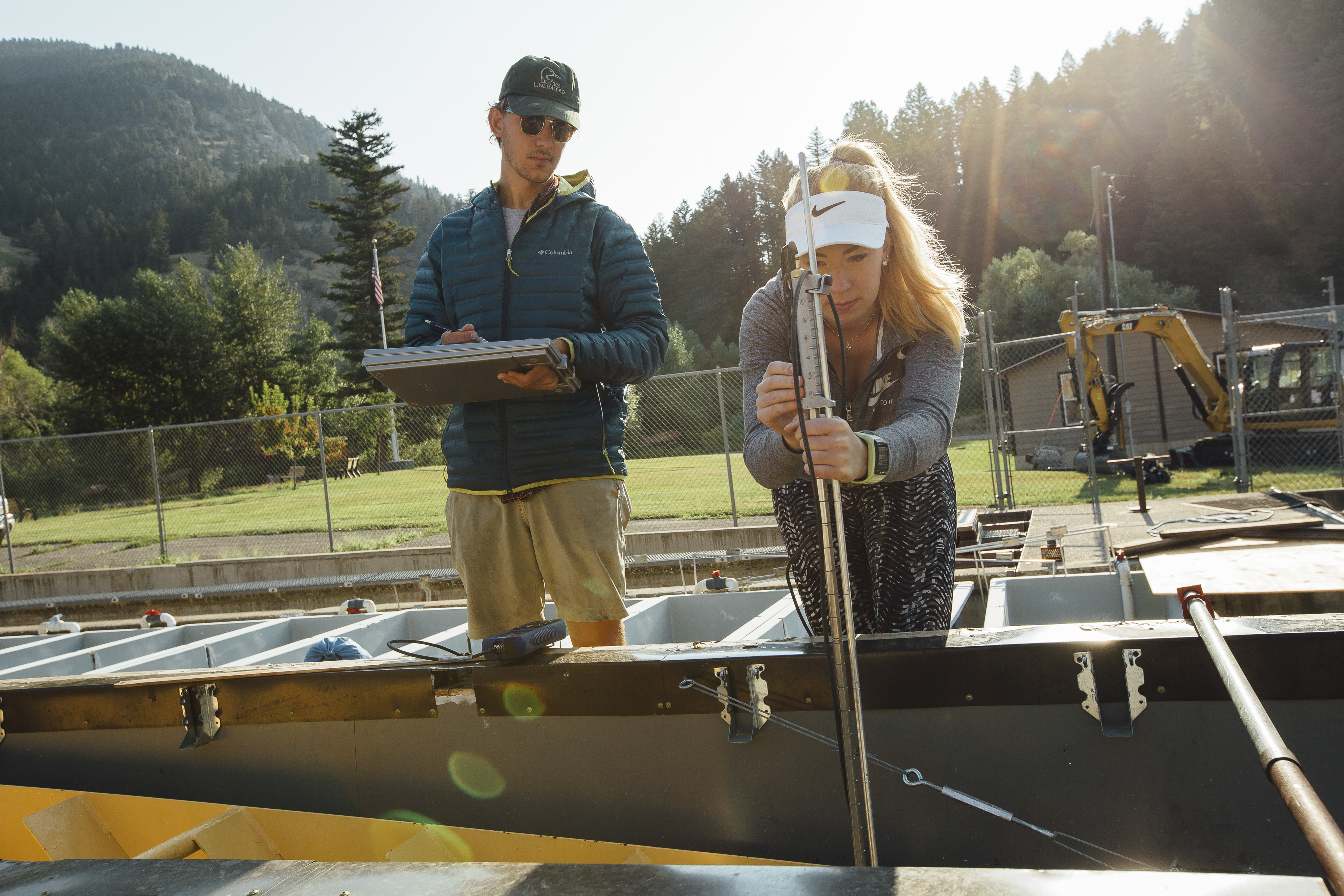 Tyler and Maddie take velocity measurements in a Denil fishway during a study evaluating flow restrictors.