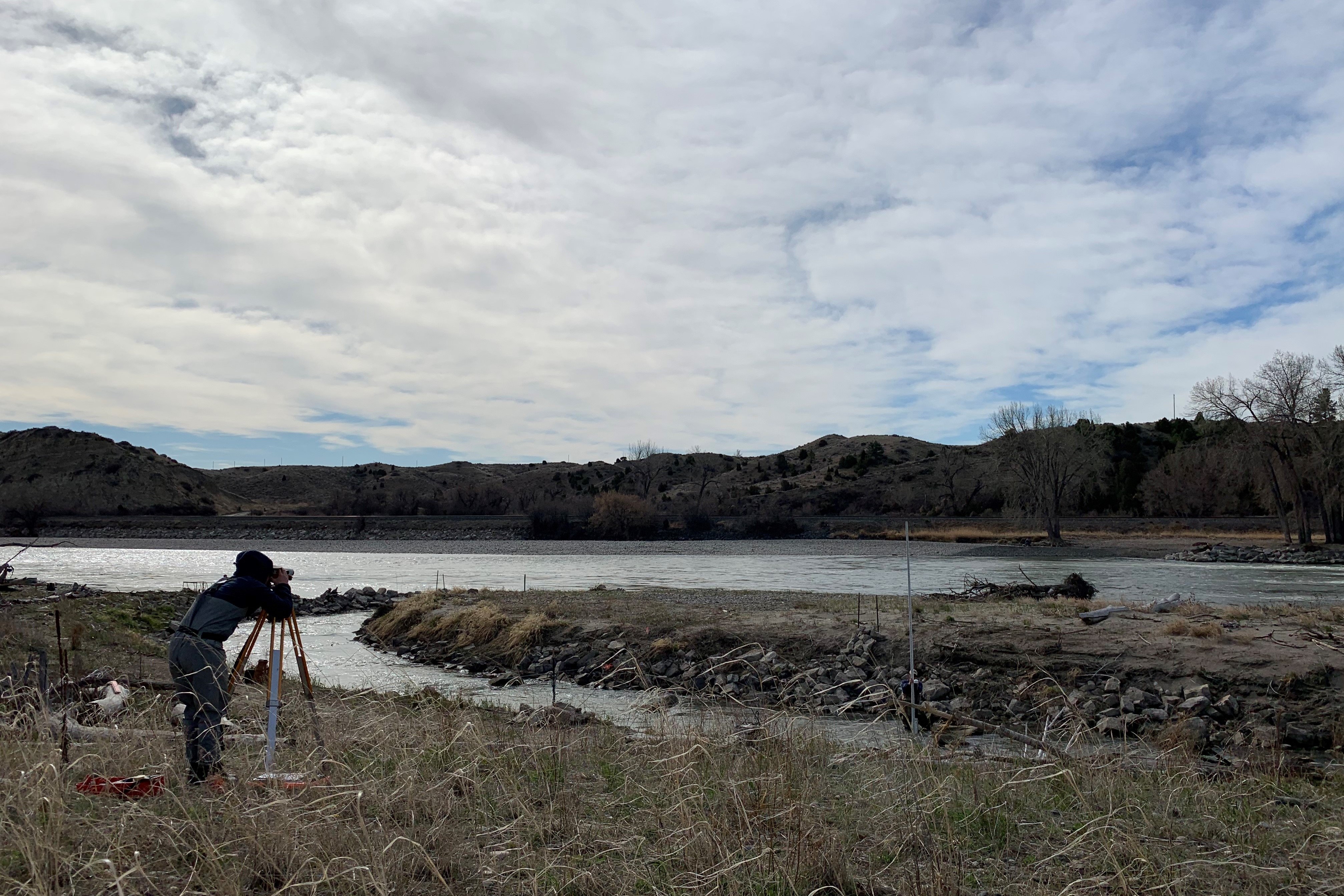 photo of haley tupen surveying at the huntley bypass channel