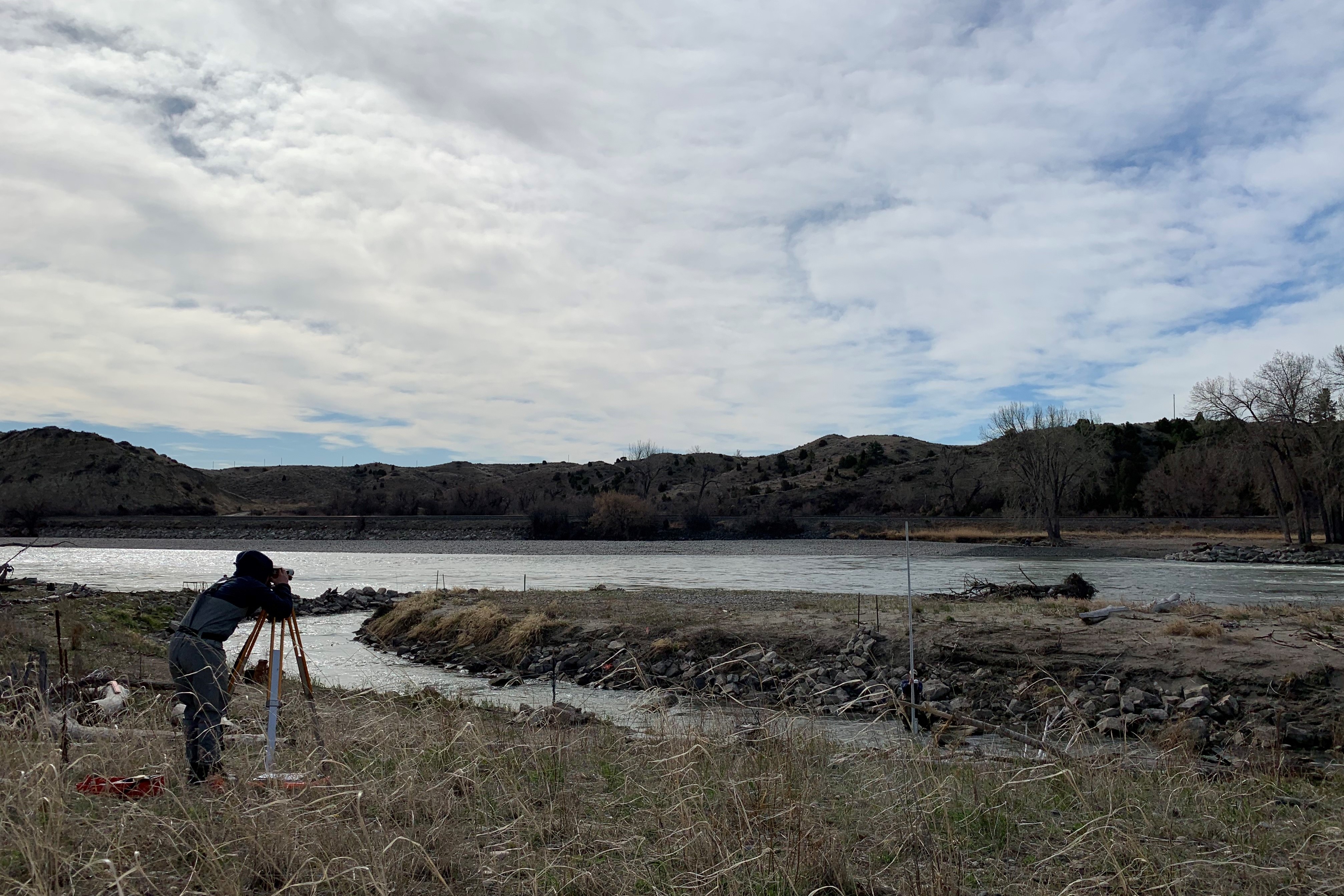 photo of haley tupen surveying at the huntley bypass channel