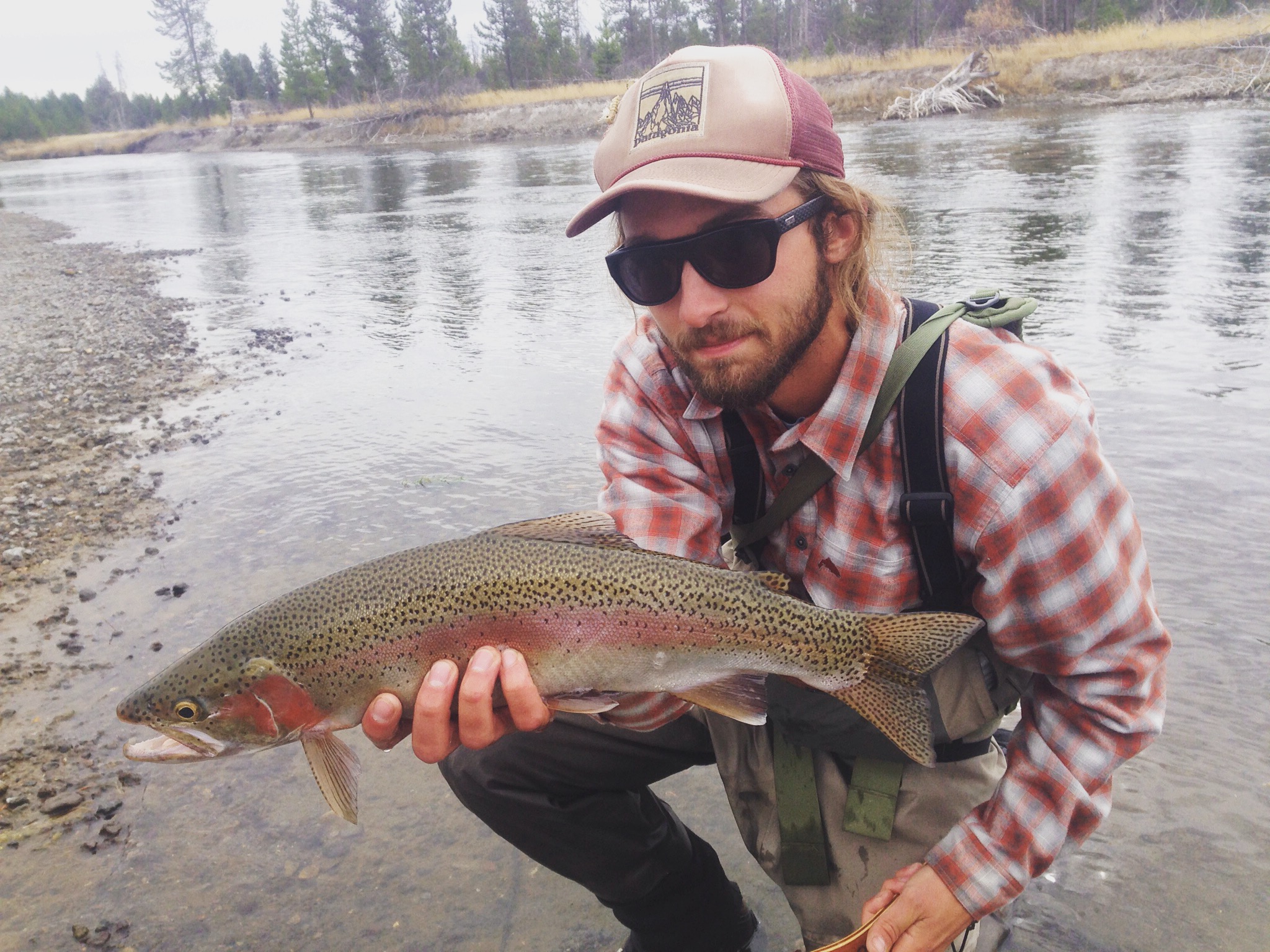 Holden holds fish on river