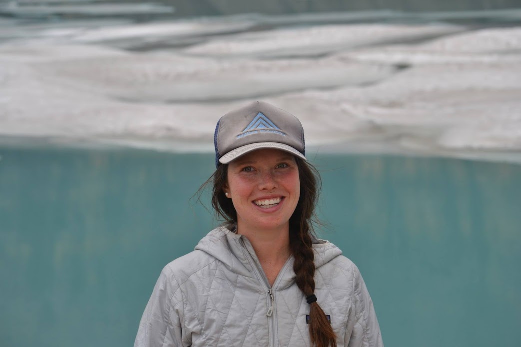 Kaitlin standing in front of aqua colored water