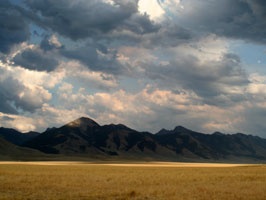 stormy clouds behind mountains and range