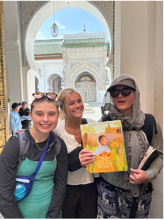 EHHD students Piper Finley, Paige Mackenstadt, and Carolyn Burrill in the Fez medina portal to al-Qarawiyyin courtyard with M.O. Yuksel’s One Wish.