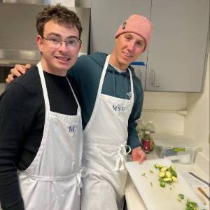 MSU LIFE Scholar student chopping veggies in kitchen
