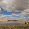 Collecting surface water for lab analysis in the Kevin Dome project area.