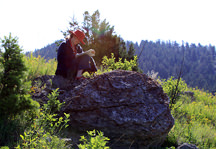 Photo: Student Reading on Rock Photo: Student Reading on Rock