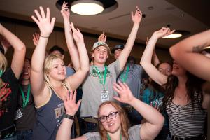 kids dancing with hands in the air