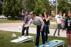 boys playing corn hole