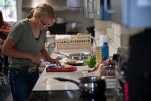 girl cutting food at counter