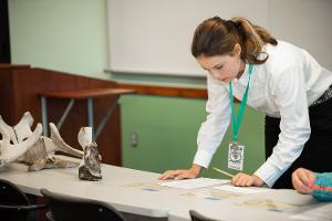 girl leaning up on table