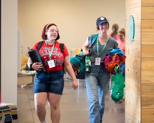 two girls walking in the dorm