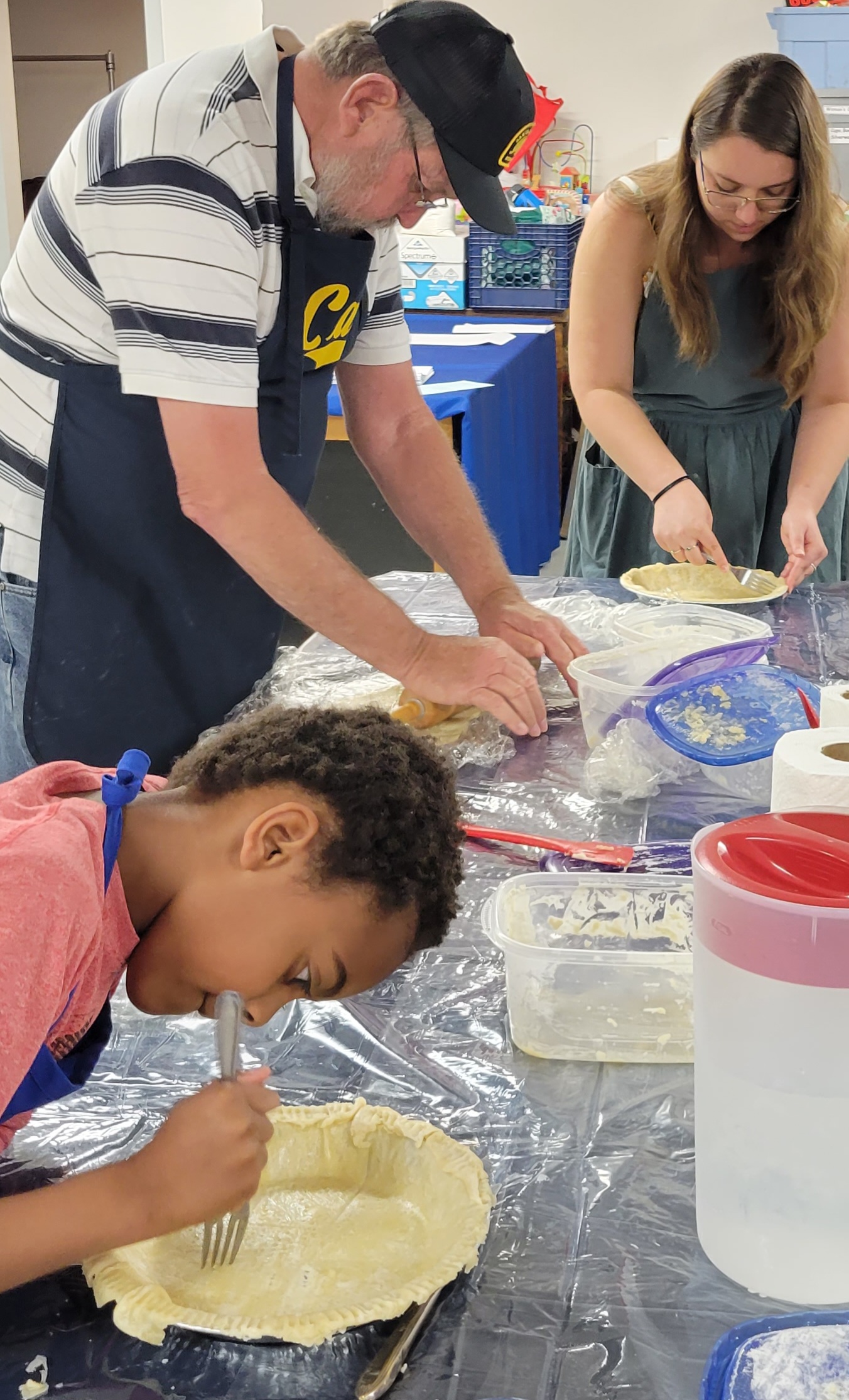 Community members making pie crust
