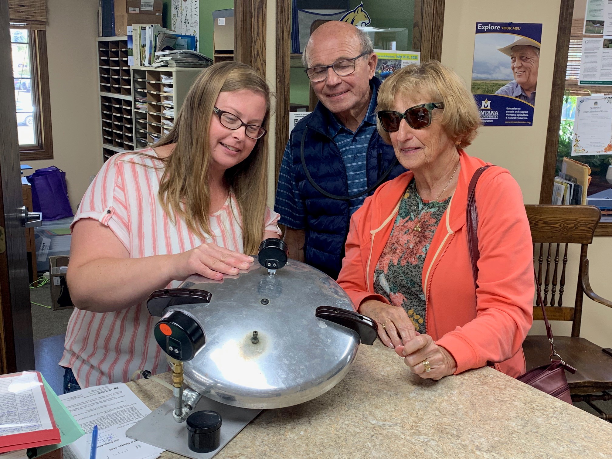 Flathead County MSU Extension Family and Consumer Sciences Extension Agent Ashli Darrach helps local family test pressure gauge.