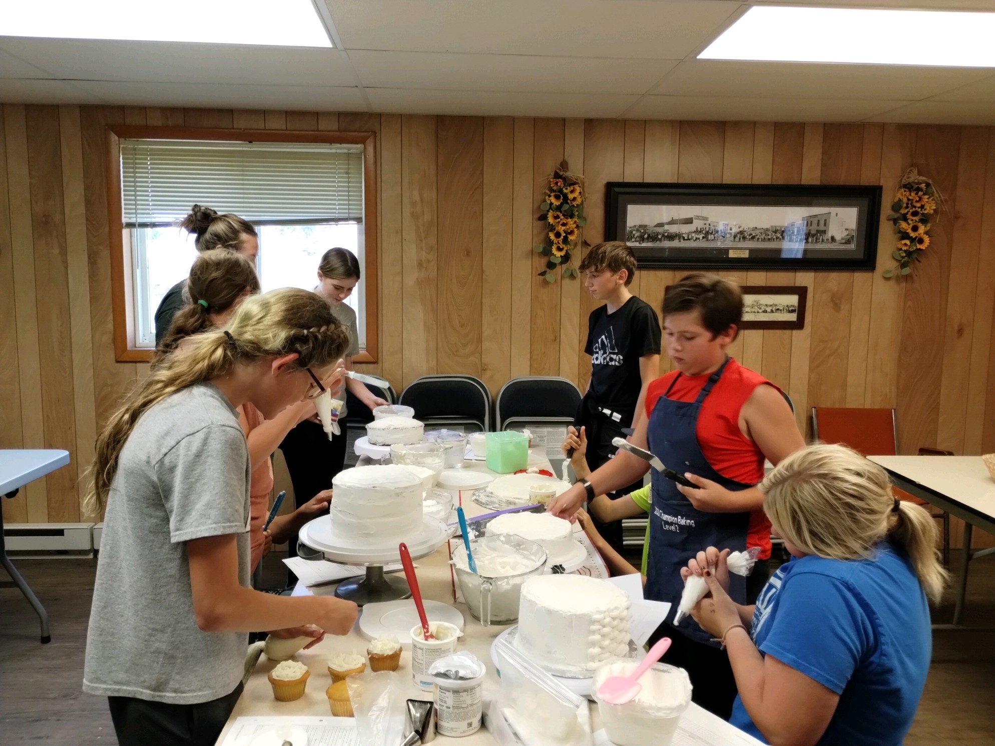 Members learning new cake decorating skills to use on their fair projects.
