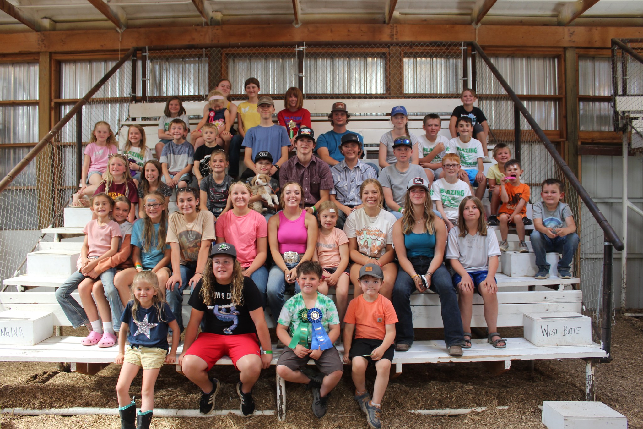 Toole County 4-H Members sit on bleachers. 