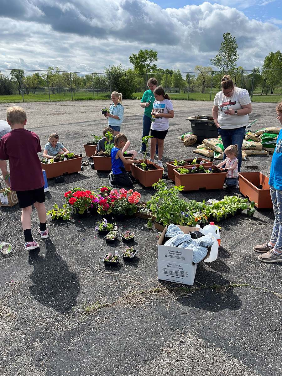 4-H youth planting their container garden