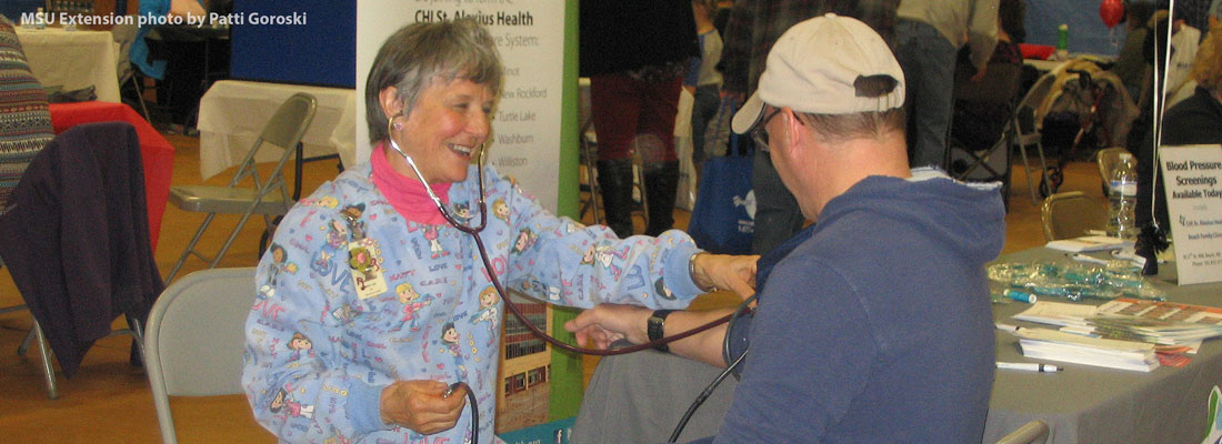 Man getting his blood pressure taken by nurse at the health fair