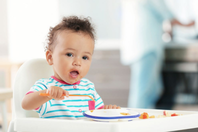 A child eating at a highchair.