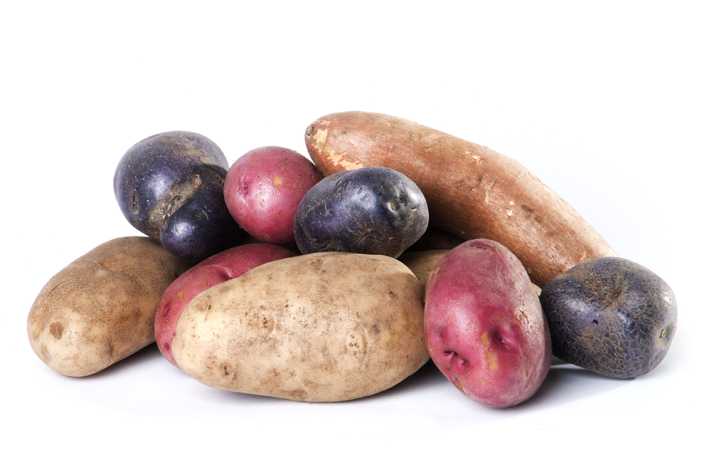 A stack of potatoes; various colors.