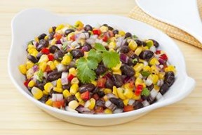 A bowl of black bean and corn salad topped with cilantro.