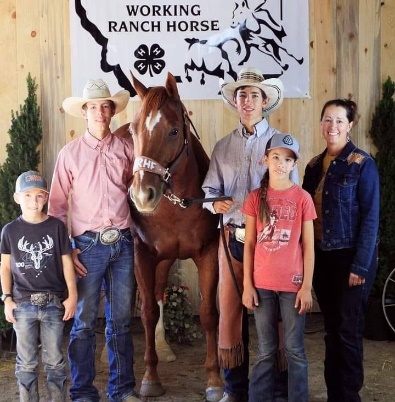Cascade County 4-H Horse Leaders photo with a working ranch horse 4-H banner in the background
