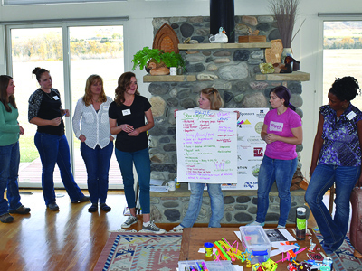 Group of women discussing ideas at training seminar.