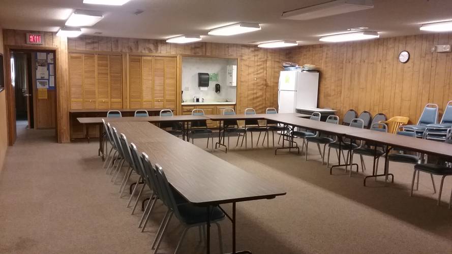 Conference room with tables, chairs, refrigerator and sink