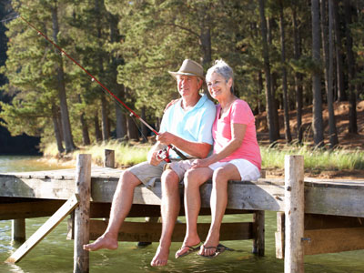 senior couple fishing on lake