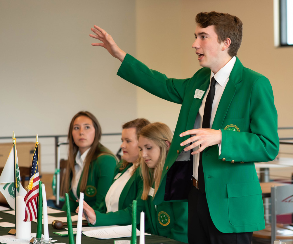 4-H members speaking at a conference.