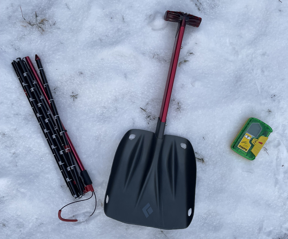 The essential tools for avalanche rescue: a probe, a shovel, and a transceiver.