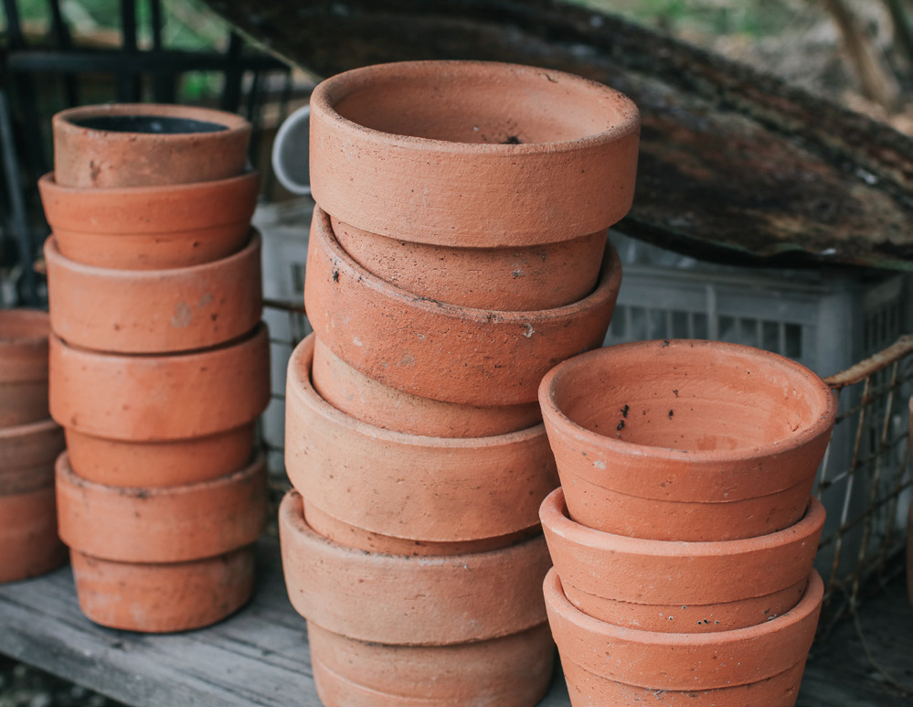a stack of reddish-brown terracotta pots