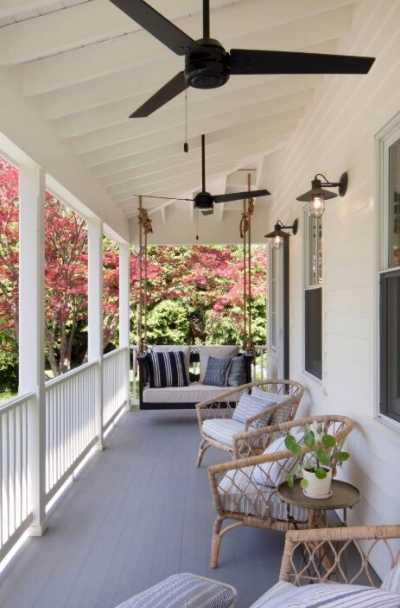 Inviting front porch with rocking chairs on summer day