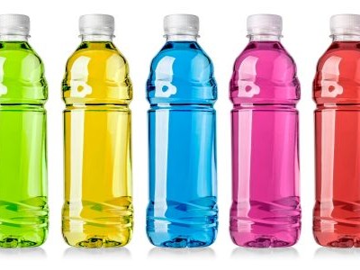 a row of plastic bottles with brightly colored liquids inside