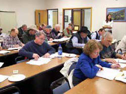 Figure 4: Photo of a classroom of adults reading papers